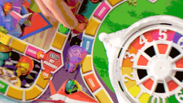 Game Of Life Sizzle with person turning the spinner and playing the game GIF full