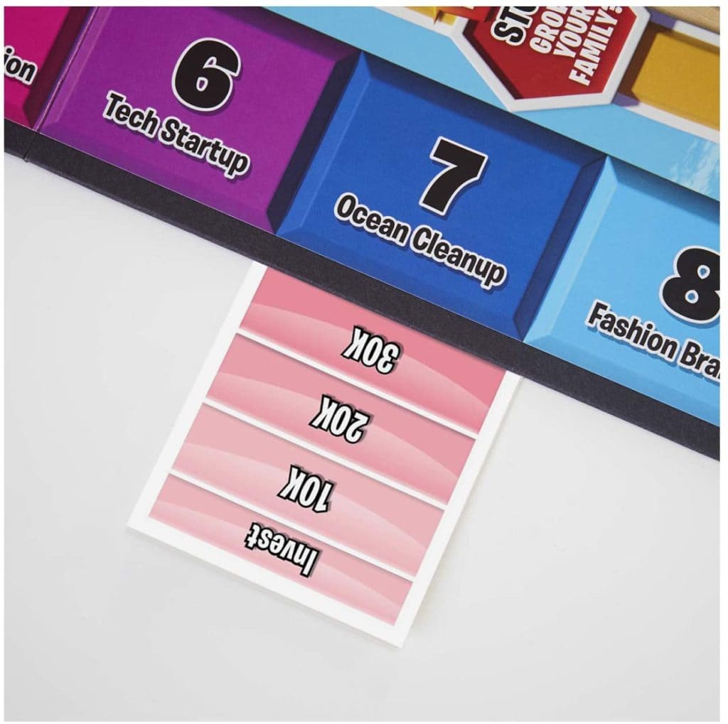 Game of Life 2021 'Your Life Your Way' in a lifestyle photoshoot with a close up on an investment card. Made by Hasbro Gaming