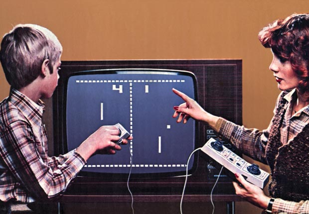 People playing Pong on an old TV