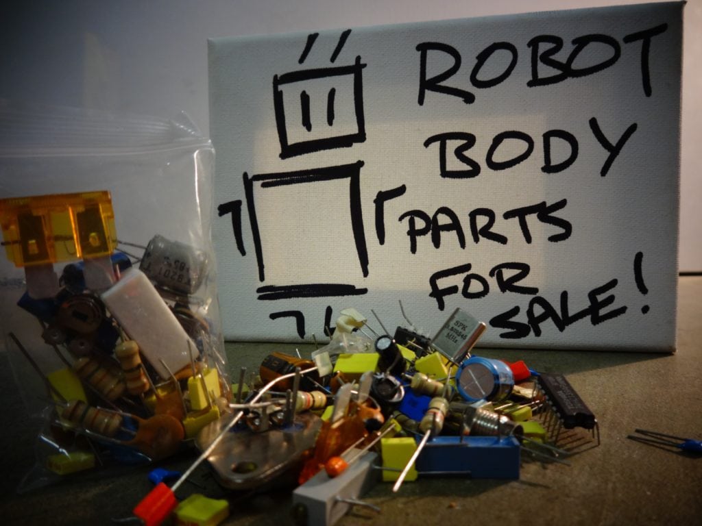 Robot Body Parts in a pile with a For Sale sign