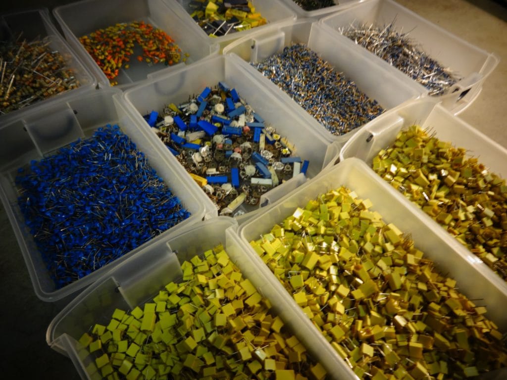 Tubs of Robot Body Parts with capacitors, resistors, and more