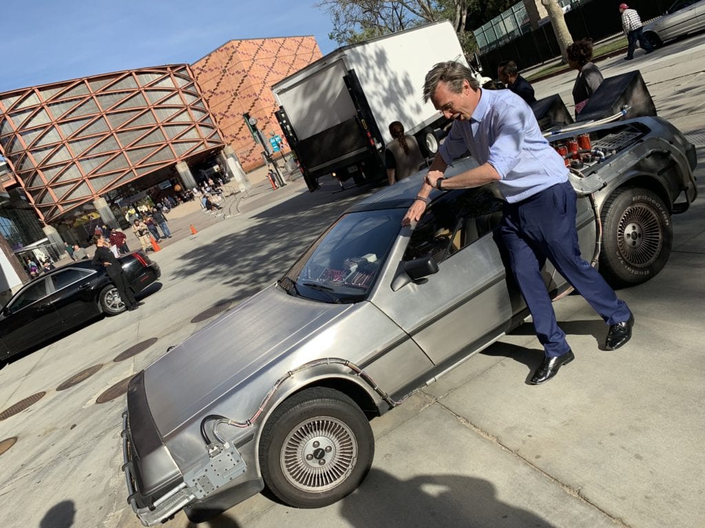 Yuri's Night and Gray Bright emcee and hot standing next to a Delorean 2019