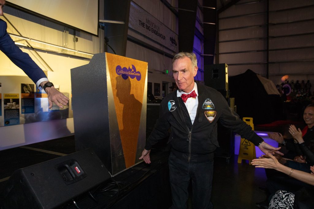 Yuri's Night with Bill Nye running in front of the stage giving hi-5's to the crowd