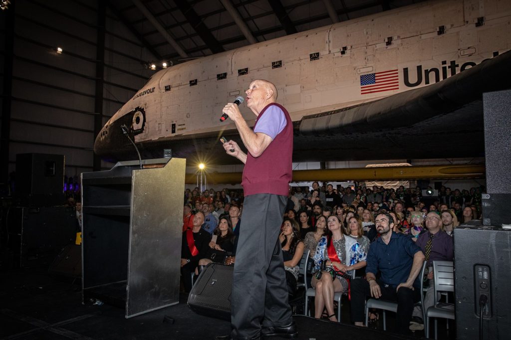 Yuri's Night Crowd with the Space Shuttle Endeavour in the background while Story Musgrave is on stage