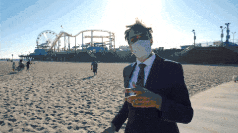 Gray Bright driving on a motorized desk along the Santa Monica beach with the Santa Monica Pier in the background